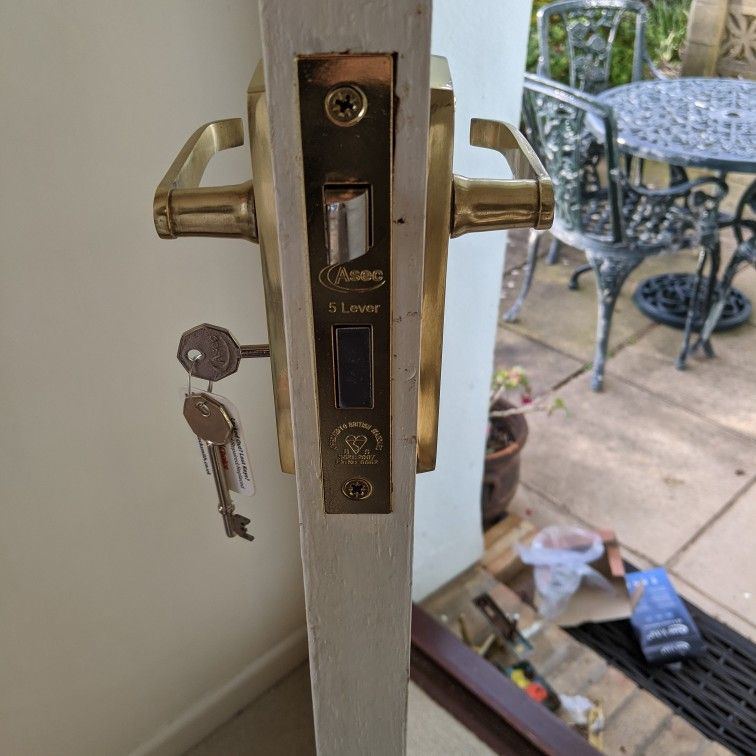 An Asec five lever mortice sashlock fitted into the edge of a timber door